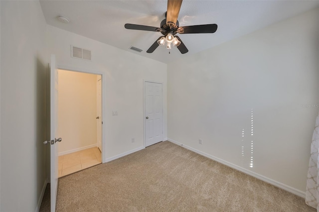 unfurnished bedroom with ceiling fan and light carpet