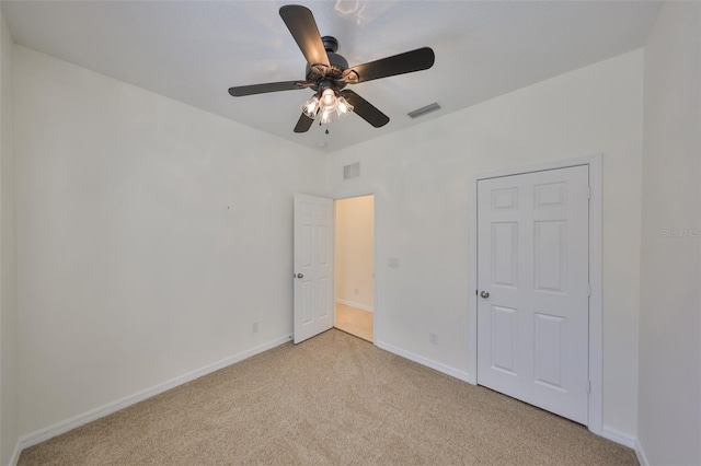 unfurnished bedroom with ceiling fan and light colored carpet