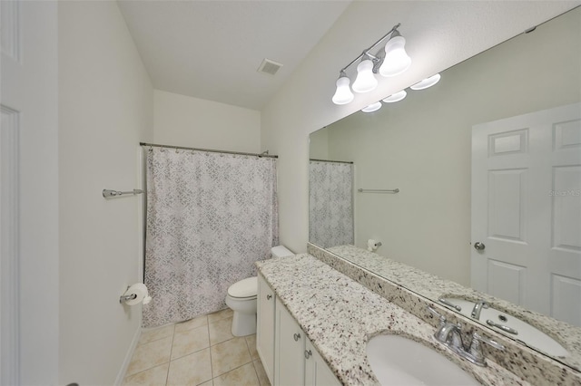 bathroom with vanity, tile patterned floors, toilet, and walk in shower