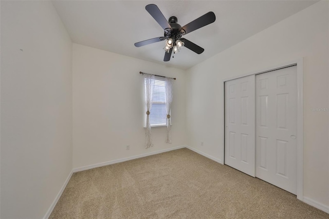 unfurnished bedroom with light carpet, a closet, and ceiling fan