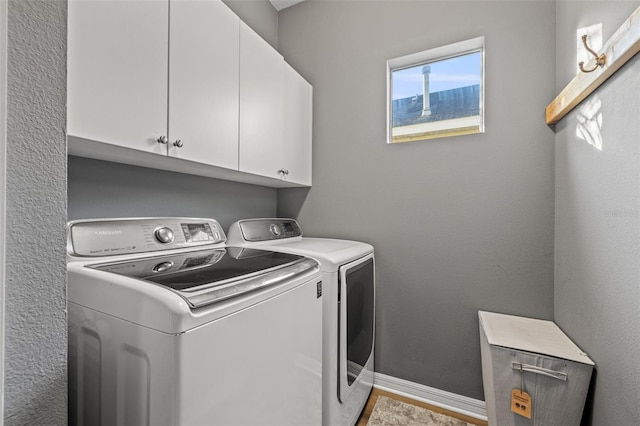 laundry room with cabinets and washer and clothes dryer