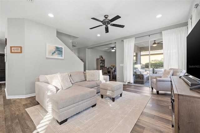 living room featuring hardwood / wood-style flooring and ceiling fan