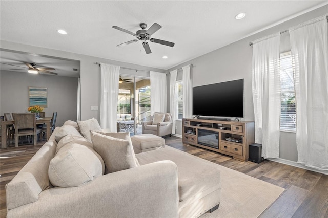 living room with hardwood / wood-style flooring and ceiling fan