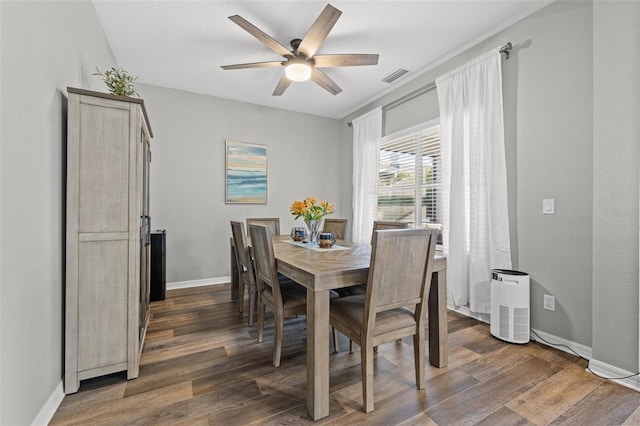 dining space featuring ceiling fan and dark hardwood / wood-style flooring