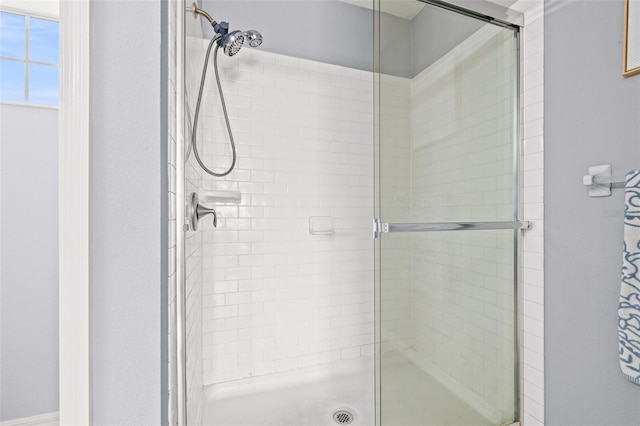 bathroom with a shower with door