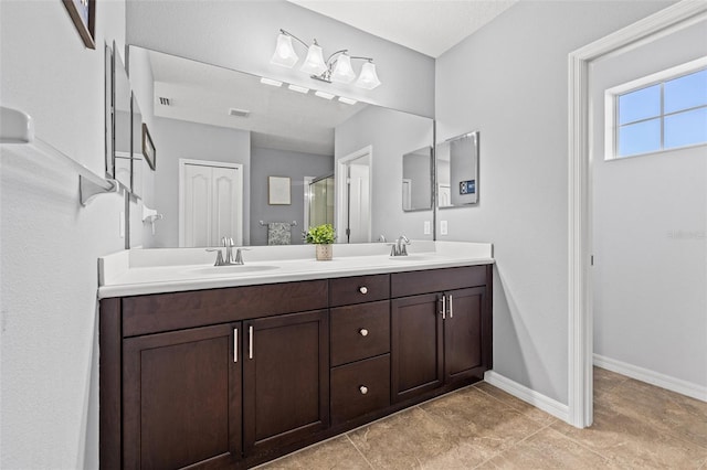 bathroom with a shower with door and vanity