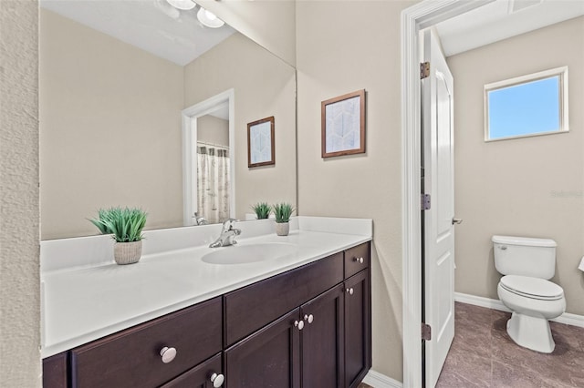 bathroom with vanity, toilet, and tile patterned flooring