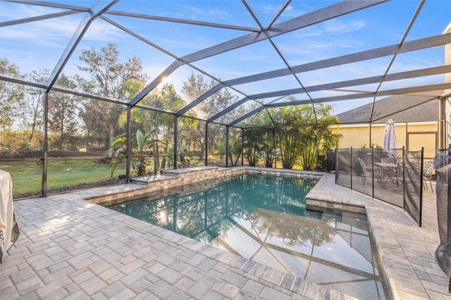 view of swimming pool with a lanai and a patio area