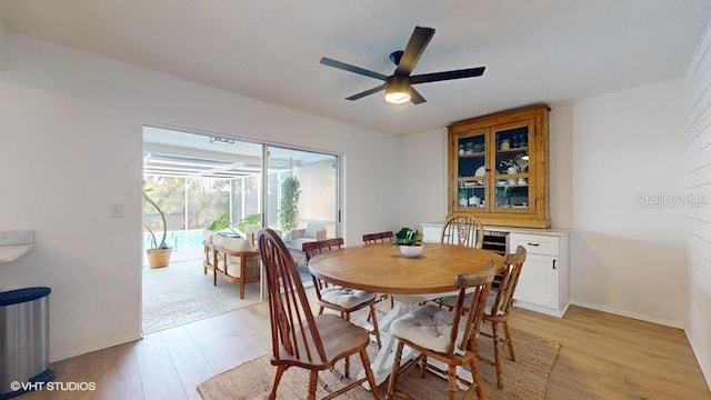 dining room featuring light hardwood / wood-style floors and ceiling fan