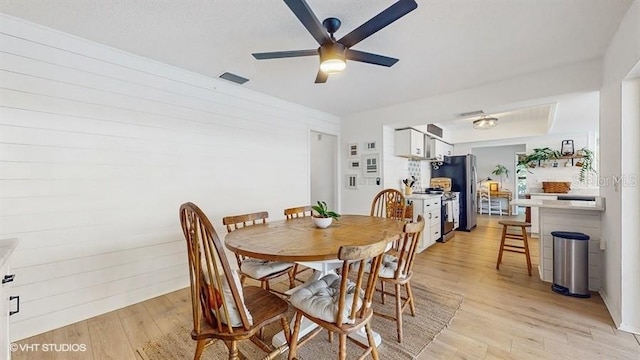 dining space featuring light hardwood / wood-style floors and ceiling fan