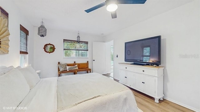 bedroom with ceiling fan and light hardwood / wood-style floors