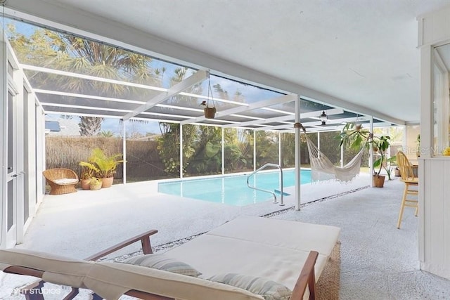 view of swimming pool featuring a patio area and glass enclosure