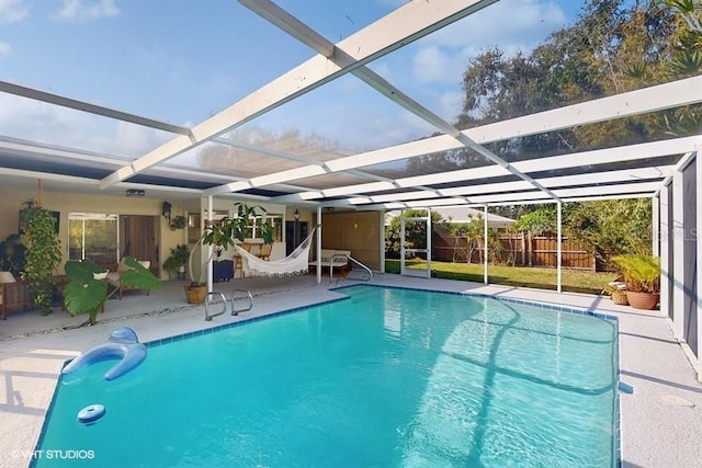 view of swimming pool featuring a patio and glass enclosure