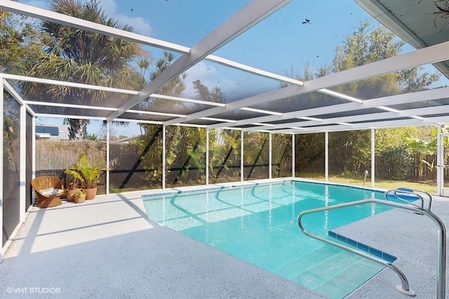 view of pool featuring a patio and glass enclosure