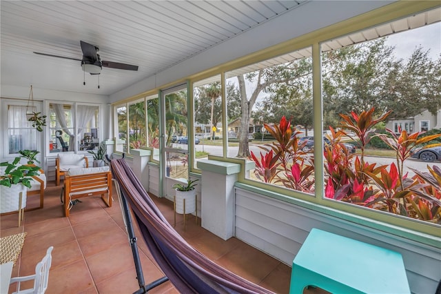 sunroom / solarium featuring ceiling fan