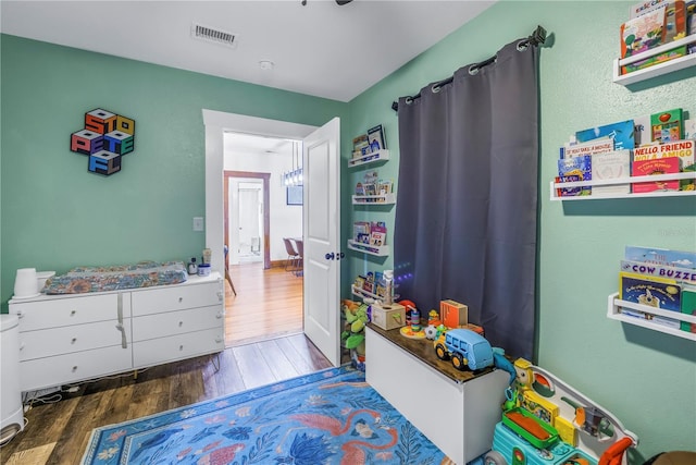 bedroom with dark hardwood / wood-style flooring