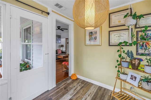 interior space with crown molding and dark hardwood / wood-style floors