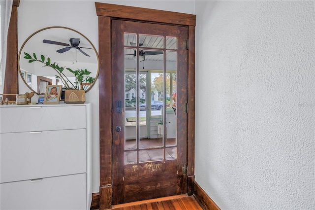 view of exterior entry featuring ceiling fan