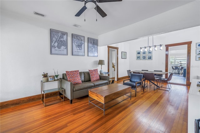 living room featuring hardwood / wood-style flooring and ceiling fan