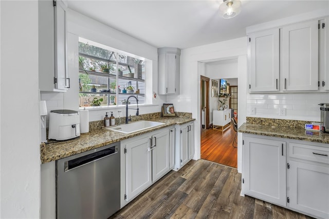 kitchen with white cabinetry, stainless steel dishwasher, and sink