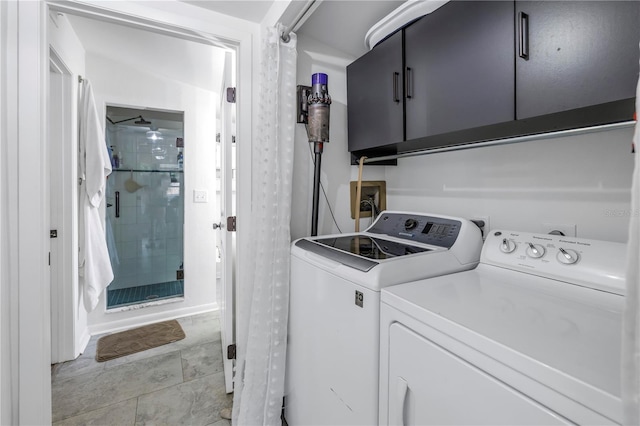 washroom with cabinets and washer and dryer