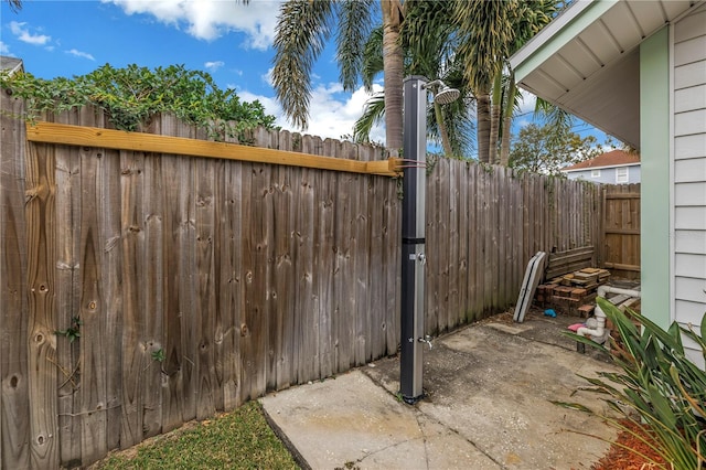 view of gate featuring a patio