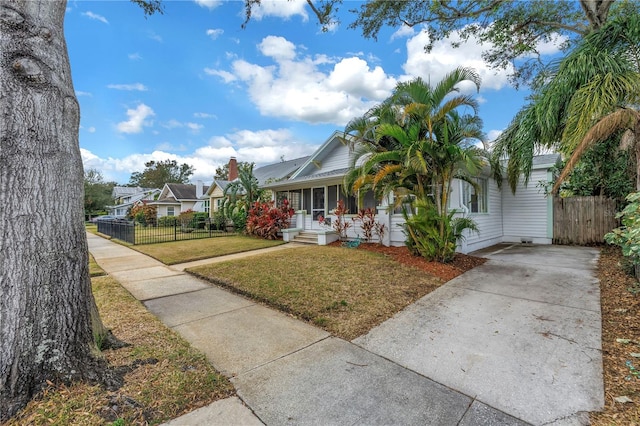 view of front of home with covered porch and a front yard