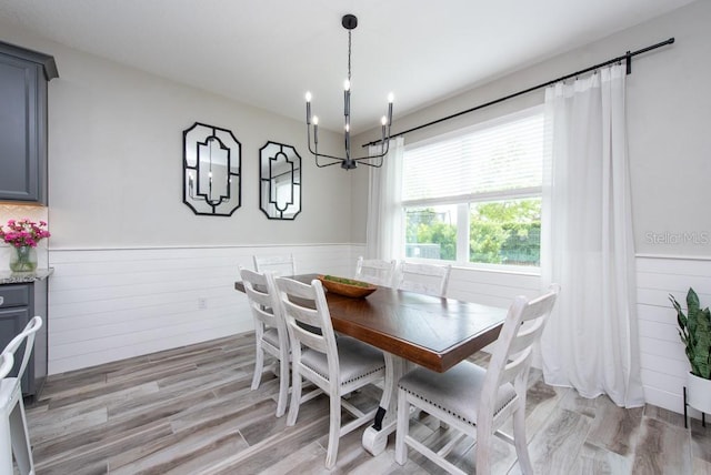 dining area featuring an inviting chandelier and light hardwood / wood-style floors