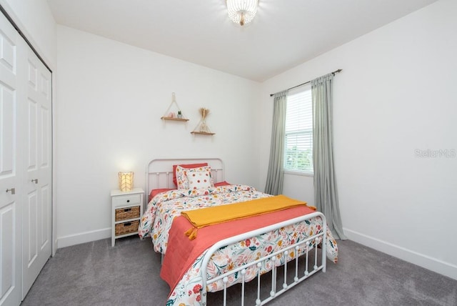 bedroom featuring dark carpet and a closet