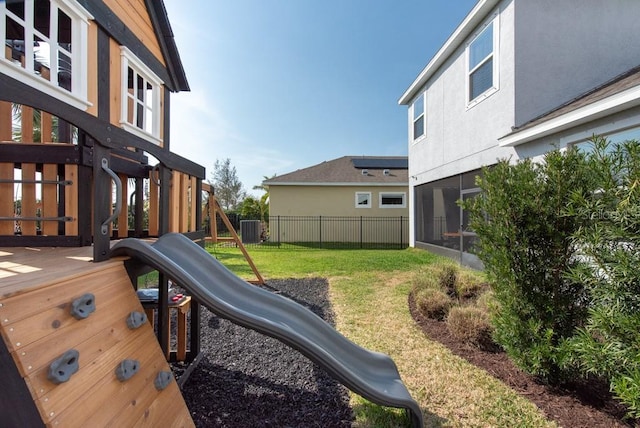 view of yard with central AC and a playground