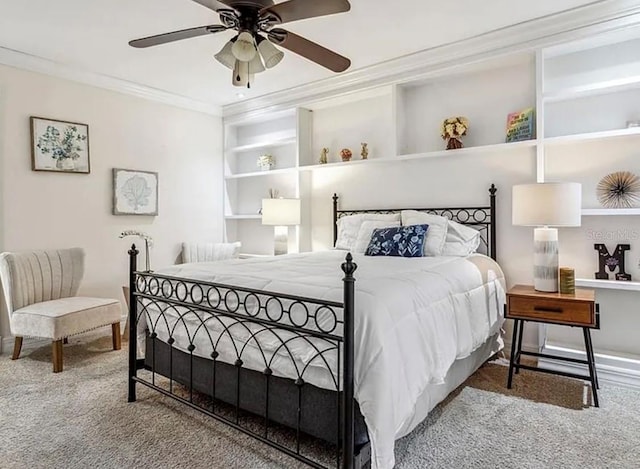 bedroom featuring ceiling fan, ornamental molding, and carpet floors