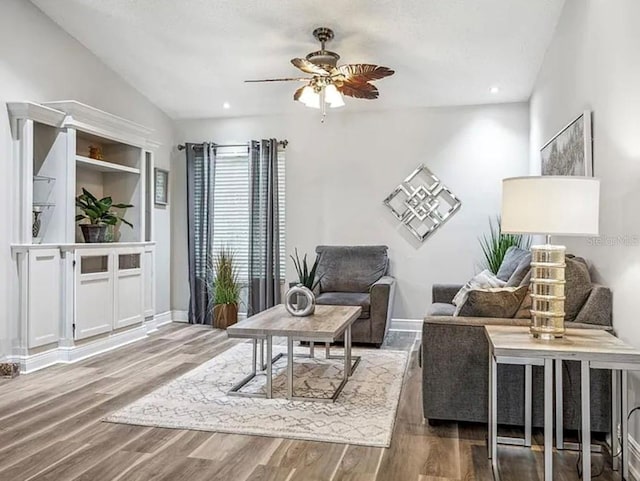 sitting room with hardwood / wood-style flooring, lofted ceiling, and ceiling fan