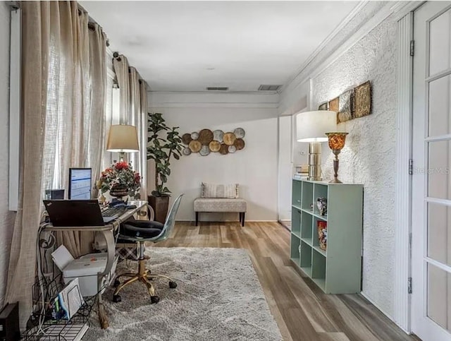 home office featuring ornamental molding and hardwood / wood-style floors