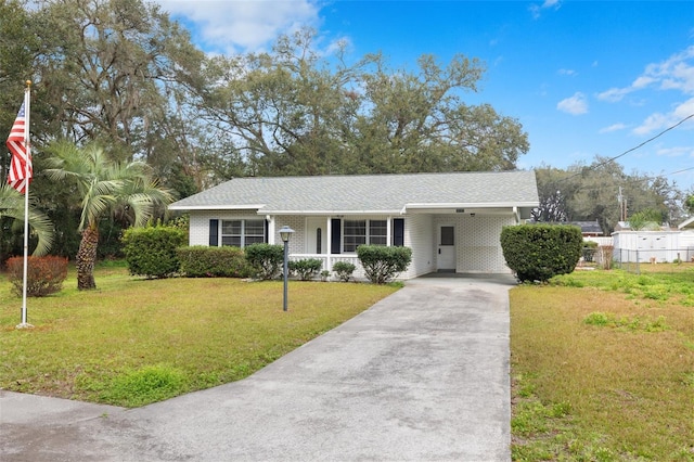 view of front of house with a carport and a front yard