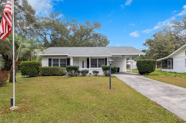 ranch-style home featuring a carport and a front yard