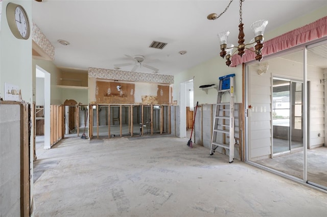 interior space featuring ceiling fan with notable chandelier