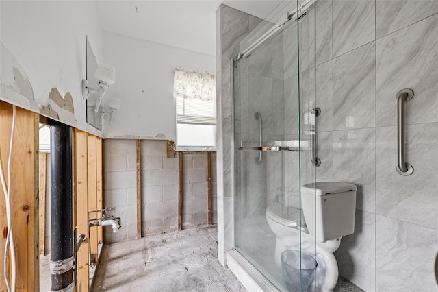 bathroom with toilet and a shower with door