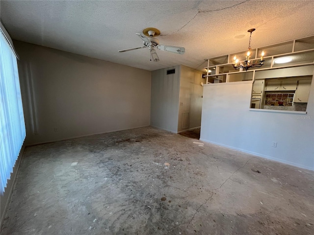 spare room with ceiling fan with notable chandelier and a textured ceiling