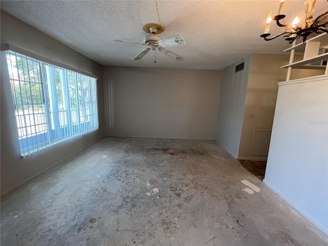 unfurnished room with ceiling fan with notable chandelier and a textured ceiling