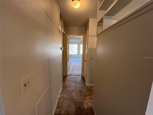 corridor with a textured ceiling