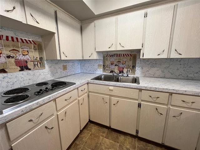 kitchen with cooktop, sink, and backsplash