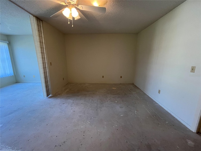 unfurnished room featuring ceiling fan, concrete flooring, and a textured ceiling