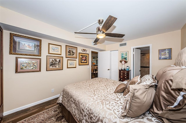 bedroom with a closet, dark hardwood / wood-style floors, ceiling fan, and ensuite bathroom