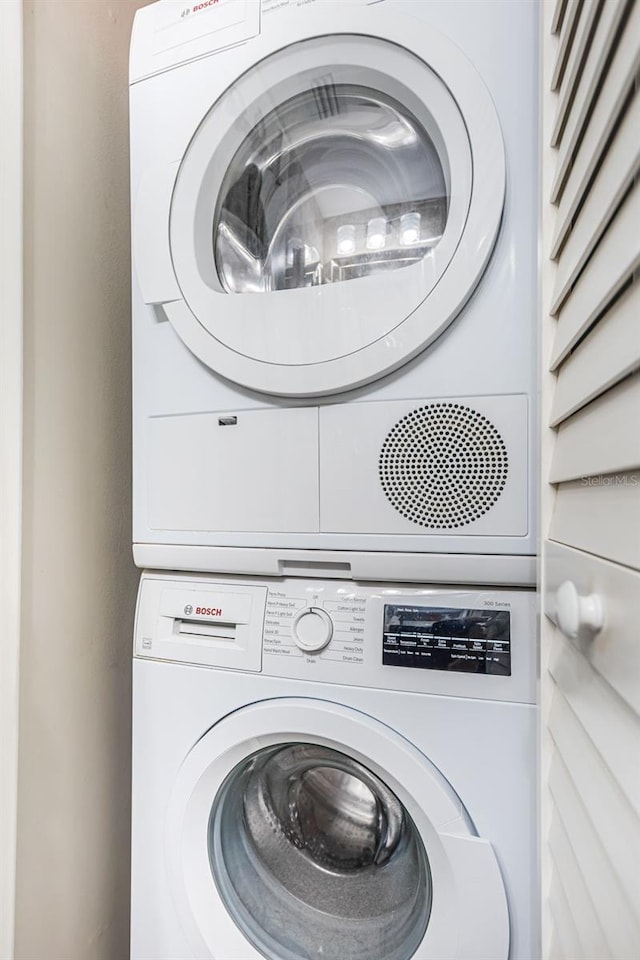 laundry room with stacked washer / dryer