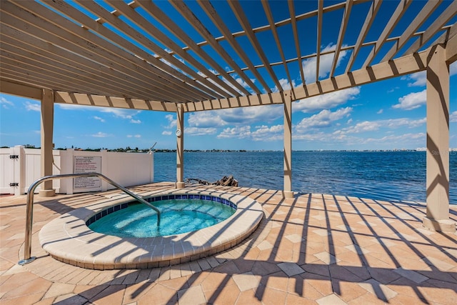 view of pool with a pergola, a hot tub, and a water view