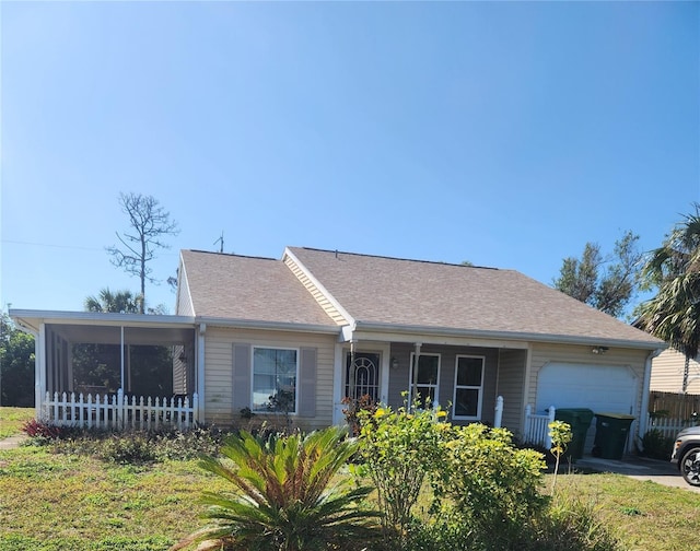 ranch-style home with a garage and a front lawn