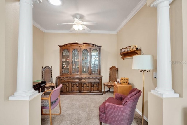 living area with ornate columns, crown molding, light colored carpet, and ceiling fan