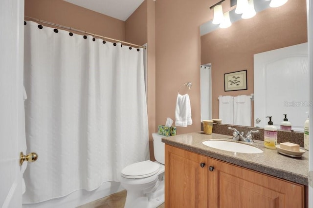 full bathroom featuring shower / tub combo with curtain, vanity, and toilet