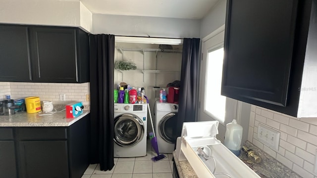 laundry area with light tile patterned flooring and washer and dryer