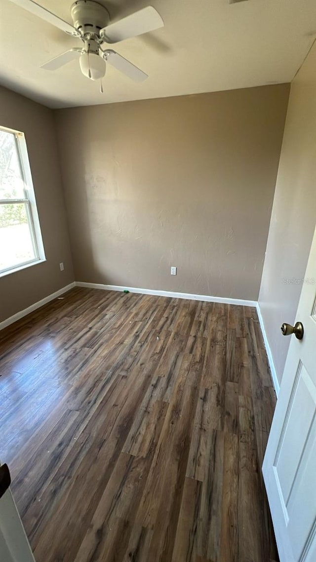 spare room featuring ceiling fan and dark hardwood / wood-style flooring